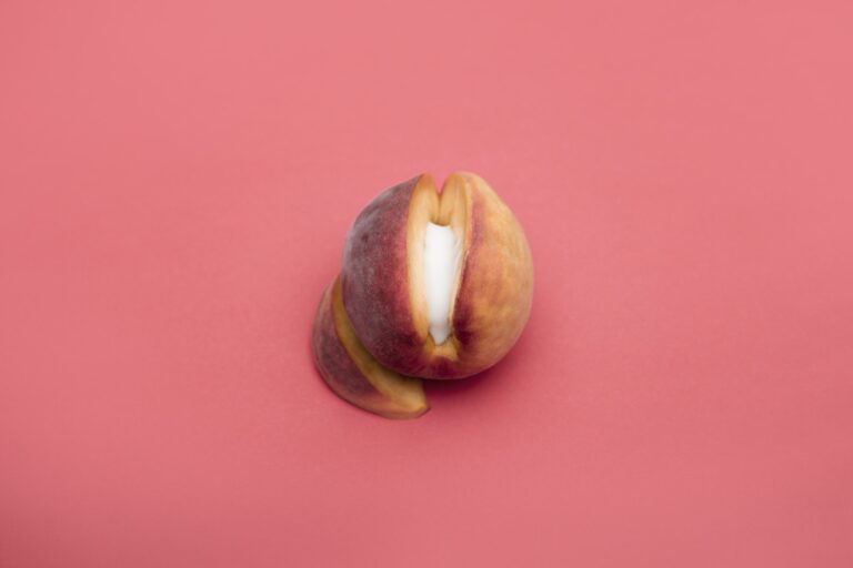 Sliced Peach Fruit on Light Pink Background
