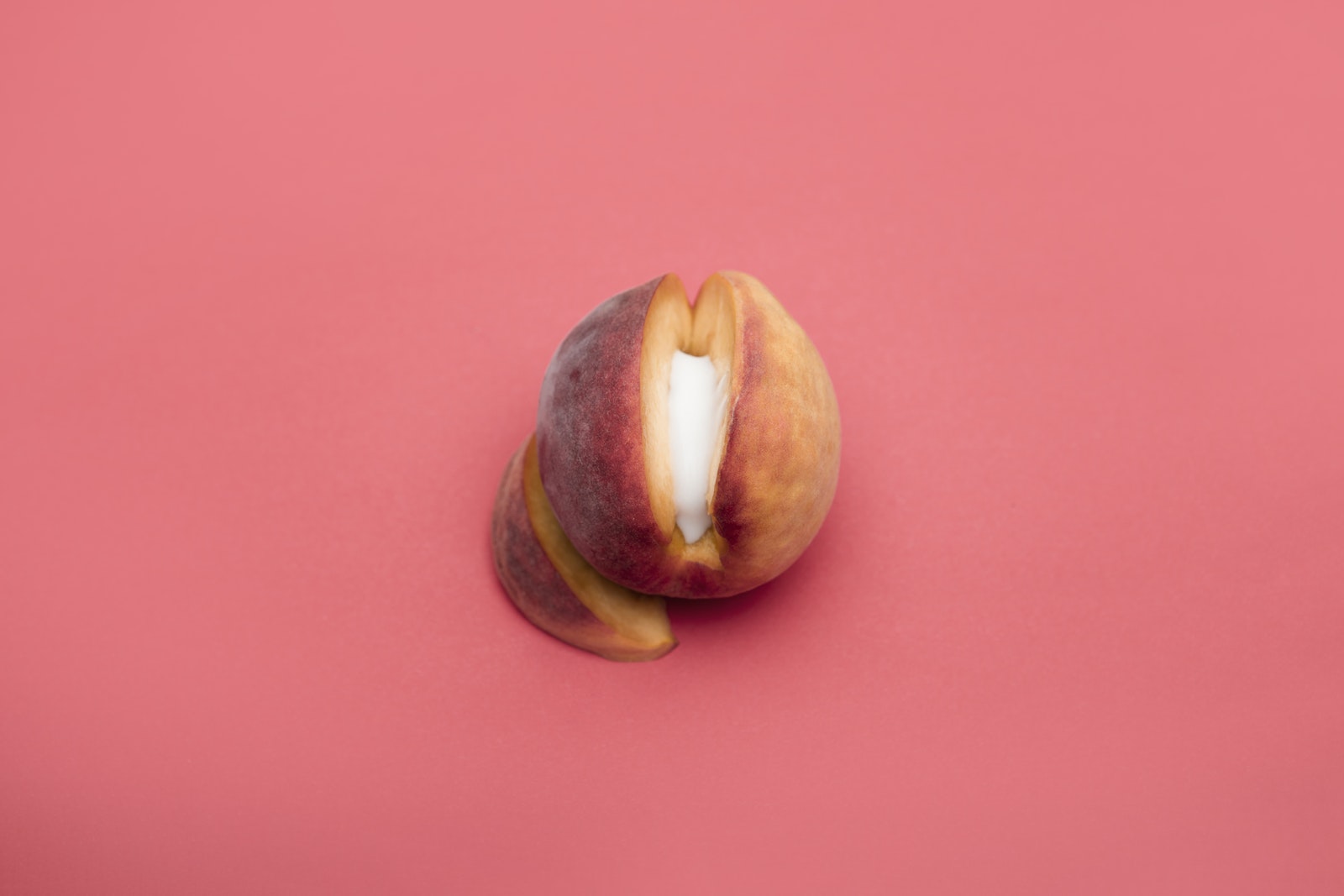 Sliced Peach Fruit on Light Pink Background